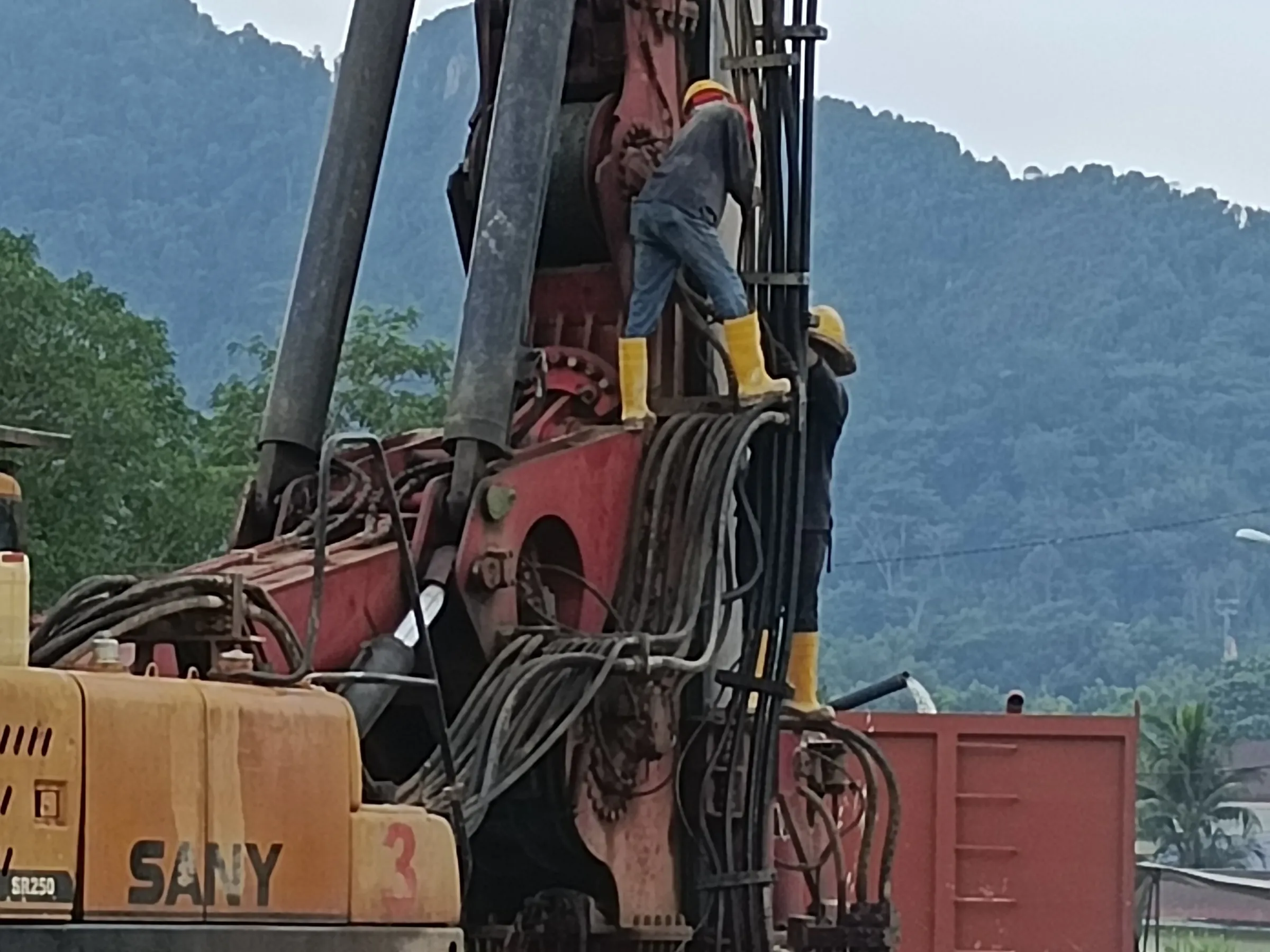 Crew working on the rotary head of a SANY SR250 bored piling rig